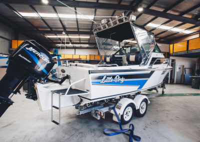A boat constructed from custom sheet metal fabrication, stored in the garage