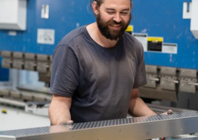 An employee carrying aluminium material for the fabrication process