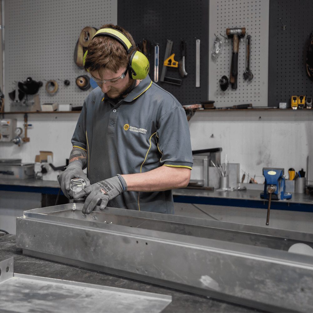 Aluminium Seating - Man working on aluminium furniture parts